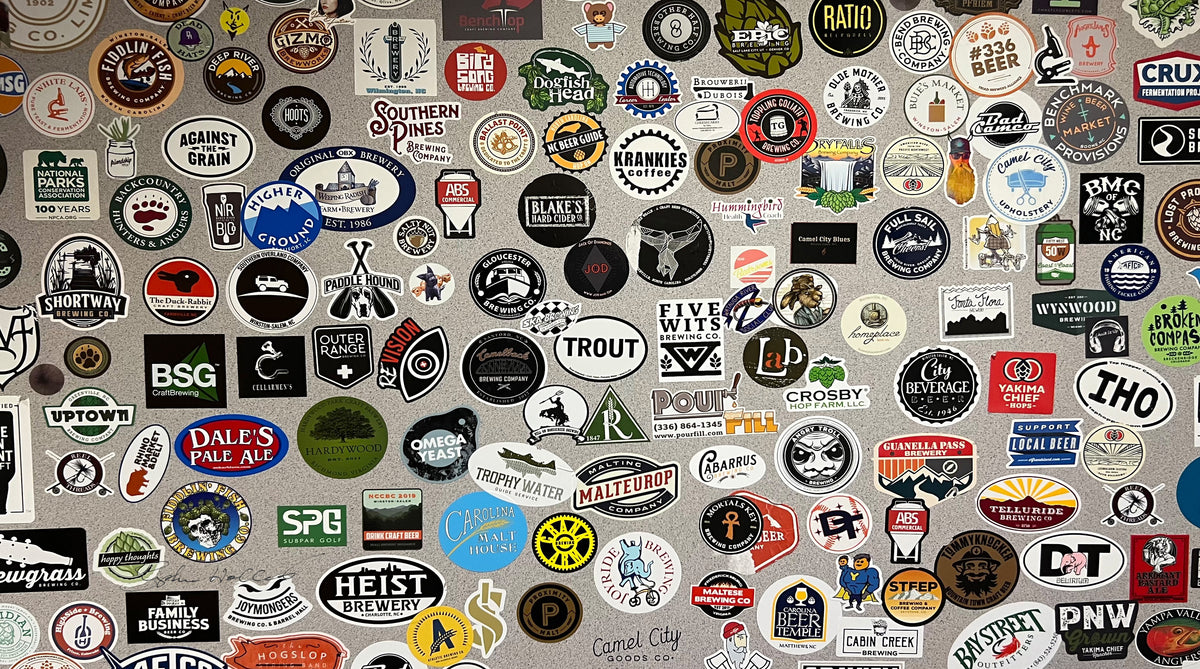 Various stickers of beer, coffee, music bands, and travel destinations as a SCÜPskin™ Deco-Sleeve for the PÜP SCÜP™ litter scoop caddy.